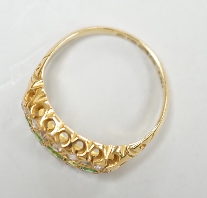 An Edwardian 18ct gold, demantoid garnet and diamond set oval cluster half hoop ring, size L, gross weight 3 grams.